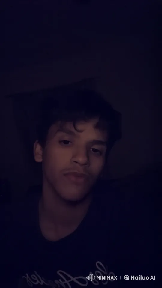 Contemplative Young Person Smokes in Dim Light – AI Generated Video | Hailuo AI