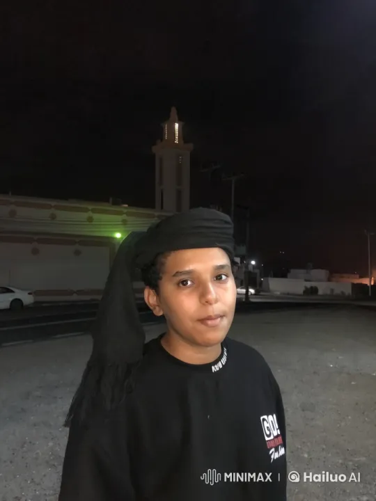 Nighttime Solitude: Young Person Smokes Outside Bright Building – AI Generated Video | Hailuo AI