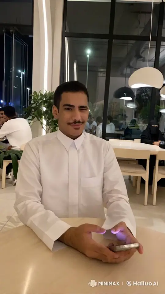 Young Man Engaging with Smartphone in Modern Setting – AI Generated Video | Hailuo AI