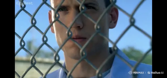 Contemplative Person Smoking Behind Chain-Link Fence – AI Generated Video | Hailuo AI