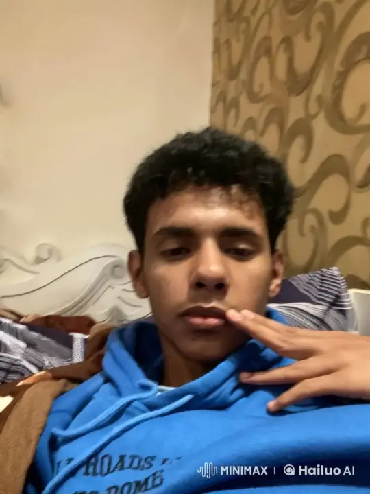 Young Man Simulates Smoking in Cozy Bedroom Setting – AI Generated Video | Hailuo AI