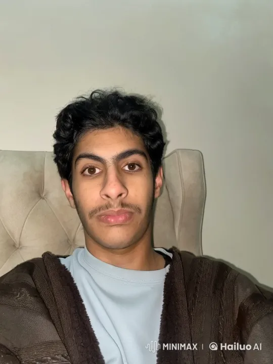 Young Man Smoking Calmly in Beige Chair – AI Generated Video | Hailuo AI