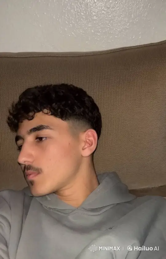 Young Man Relaxing and Smoking on a Couch – AI Generated Video | Hailuo AI