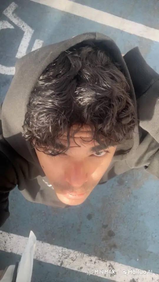 Person Smoking in Parking Lot with Reflective Stance – AI Generated Video | Hailuo AI