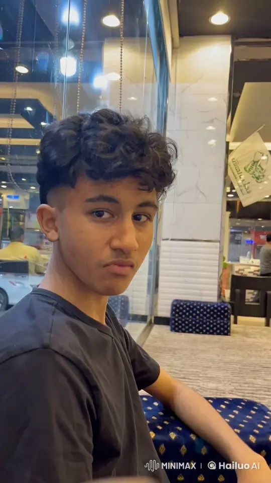 Young Man Smoking in Reflective Indoor Space – AI Generated Video | Hailuo AI