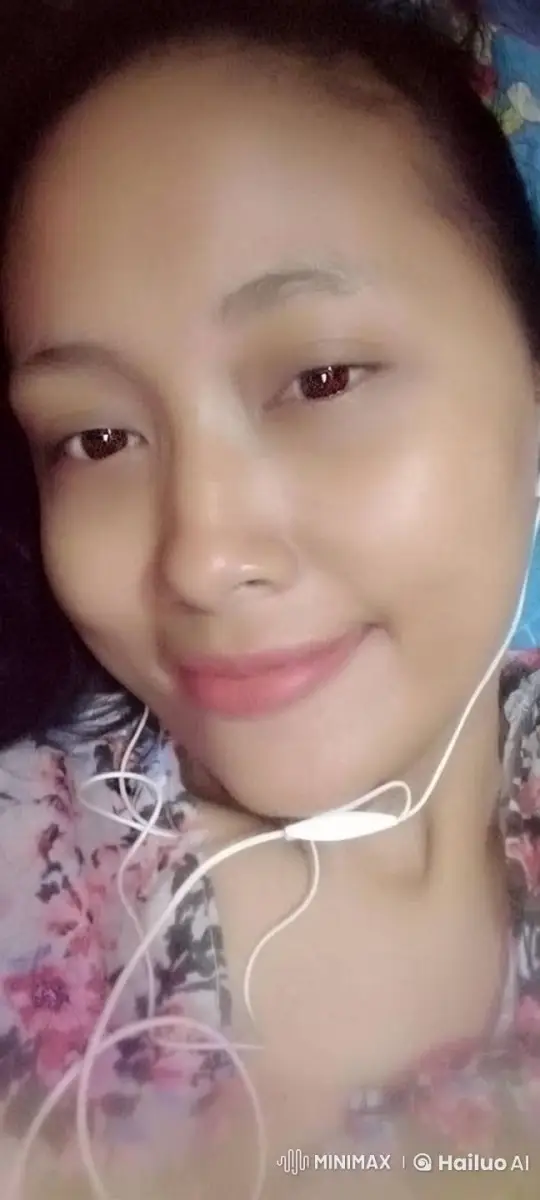Woman in Floral Top with Earphones, Serene Expression – AI Generated Video | Hailuo AI
