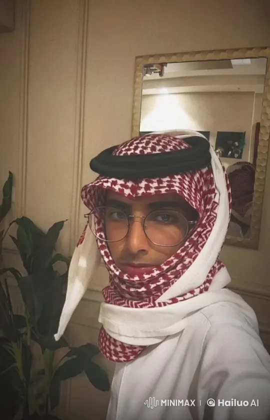Traditional Attire: Man Reflects with Cigarette in Beige Room – AI Generated Video | Hailuo AI