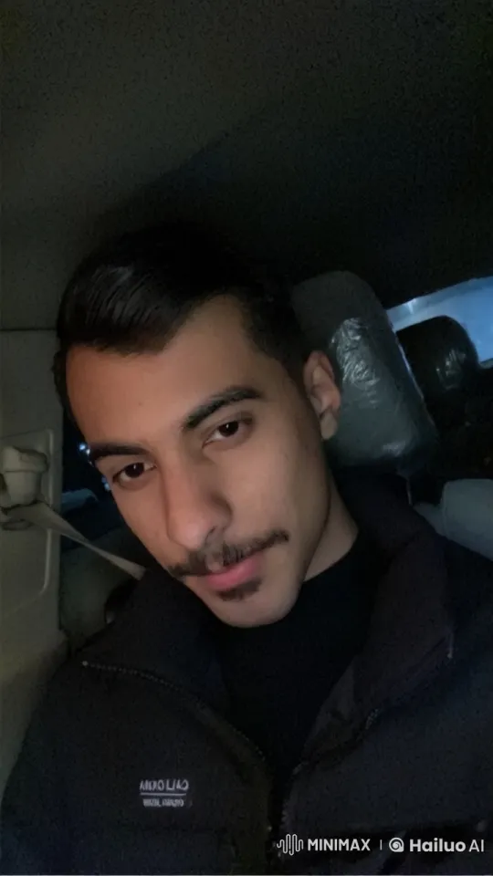 Young Man Reflects in Dimly Lit Car with Cigarette – AI Generated Video | Hailuo AI