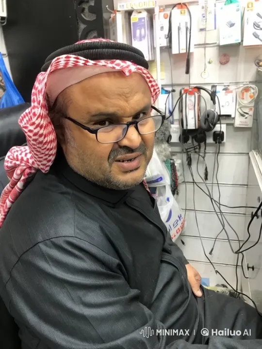 Contemplative Shopkeeper Amidst Electronic宁静 – AI Generated Video | Hailuo AI