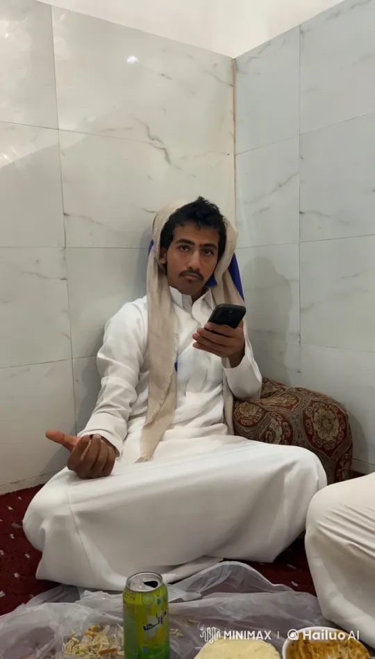 Man Relaxing with Phone and Cigarette in Traditional Room – AI Generated Video | Hailuo AI