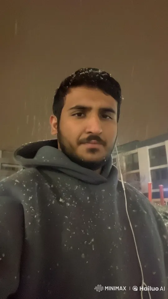 Young Man Contemplates in Snowy Night Street – AI Generated Video | Hailuo AI