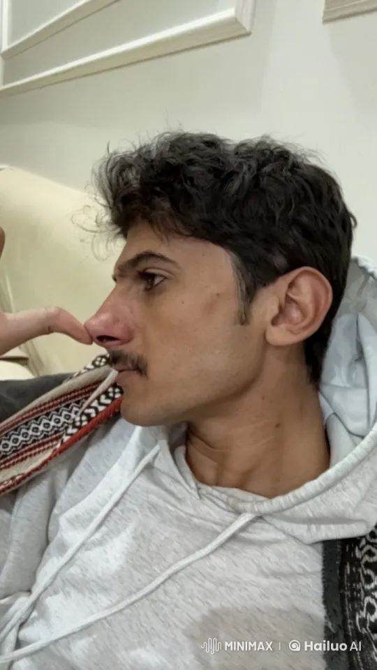 Relaxed Person Smoking on Beige Couch – AI Generated Video | Hailuo AI