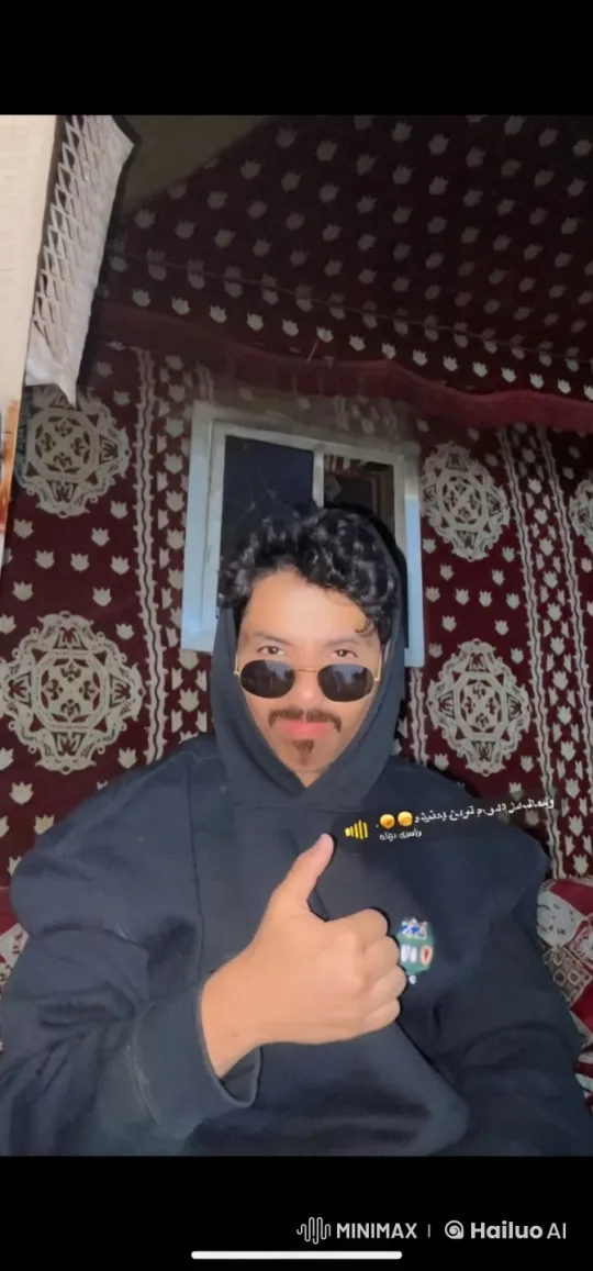 Person in Hoodie Smokes in Patterned Tent – AI Generated Video | Hailuo AI
