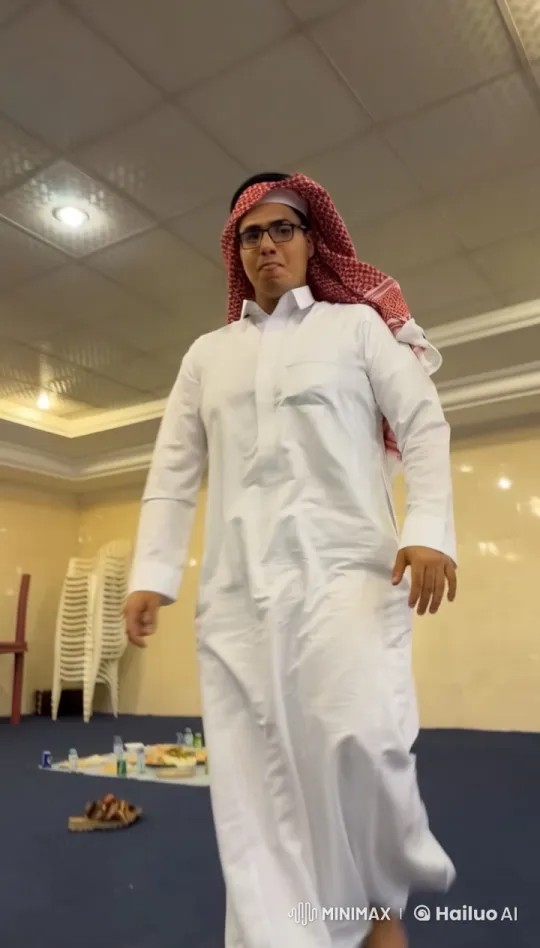 Man in Thobe Smokes Cigarette in Bright Indoor Room – AI Generated Video | Hailuo AI