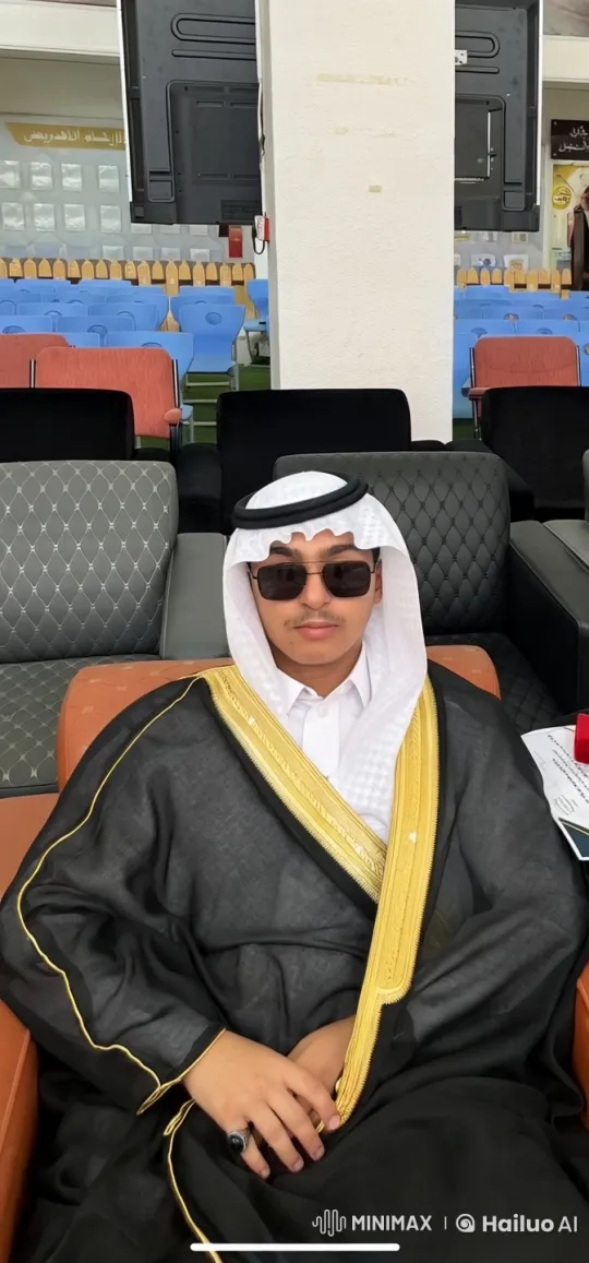 Young Man in Traditional Attire Smokes in Indoor Hall – AI Generated Video | Hailuo AI