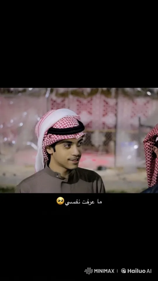 Man in Keffiyeh Smokes, Converses in Ambiguous Setting – AI Generated Video | Hailuo AI