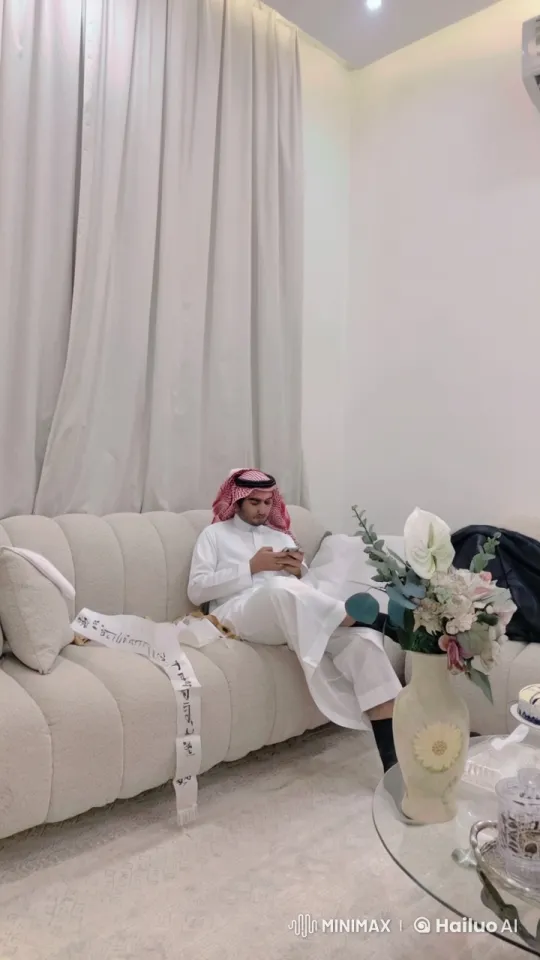 Modern Living Room with Traditional Attire and Relaxing Atmosphere – AI Generated Video | Hailuo AI