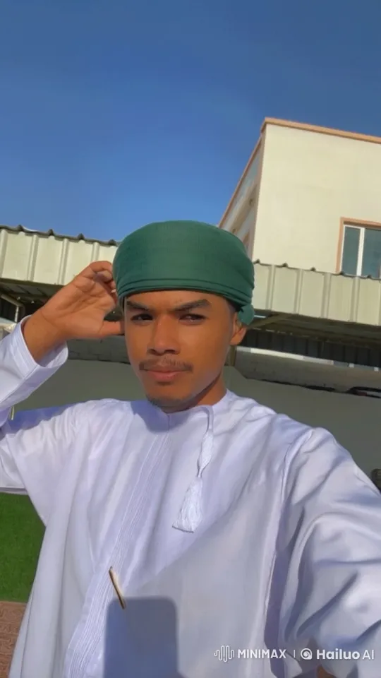 Man in Traditional Attire Smokes in Sunlit Outdoor Setting – AI Generated Video | Hailuo AI