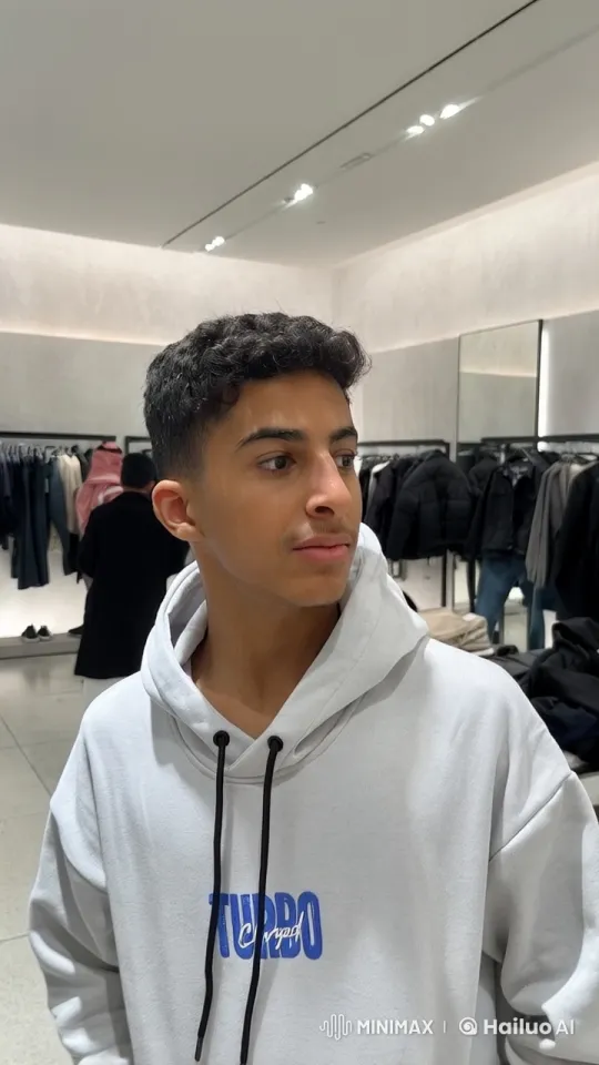 Young Man Vapes in Modern Clothing Store – AI Generated Video | Hailuo AI