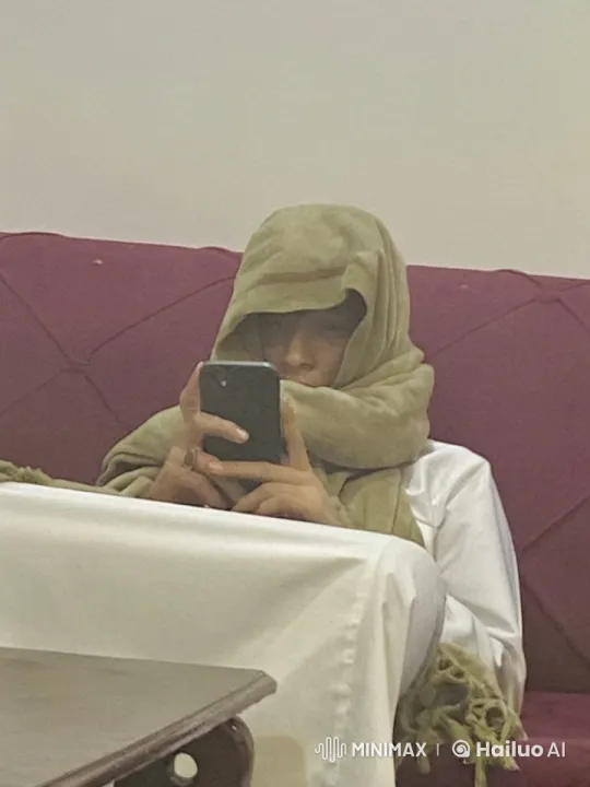 Person Relaxing on Sofa, Engaged with Smartphone and Smoking – AI Generated Video | Hailuo AI