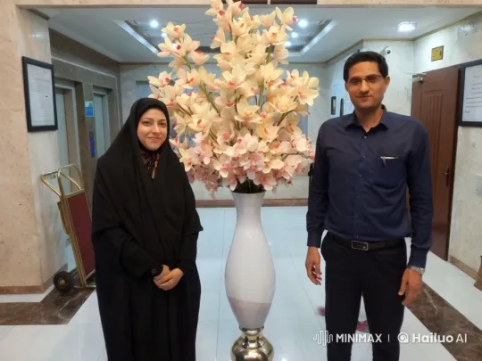 Two Individuals Smiling in a Well-Lit Lobby Setting – AI Generated Video | Hailuo AI