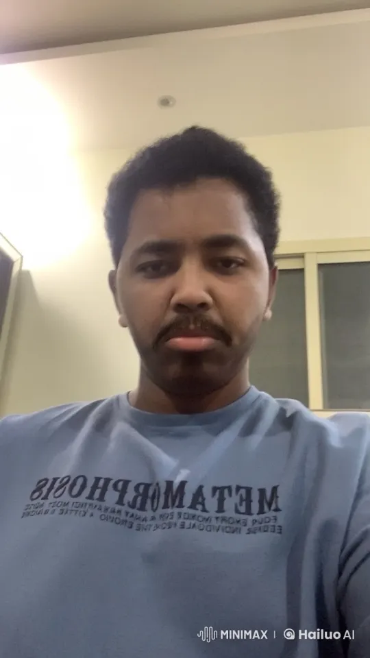 Indoor Smoking Scene with 'METAMORPHOSIS' Shirt – AI Generated Video | Hailuo AI