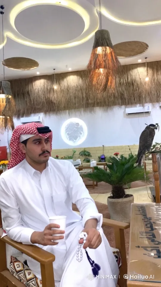 Man Smokes and Meditates with Falcon in Traditional Setting – AI Generated Video | Hailuo AI