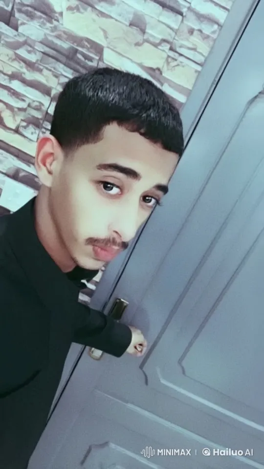 Young Man Contemplates with a Cigarette by a Gray Door – AI Generated Video | Hailuo AI