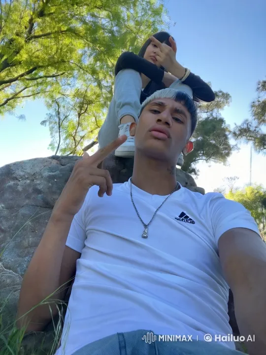 Young friends relax on rock, share a moment – AI Generated Video | Hailuo AI