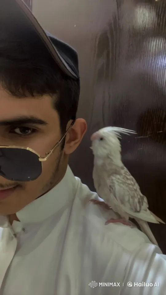 Person in White Outfit Smokes, Speckled Cockatiel Perched – AI Generated Video | Hailuo AI