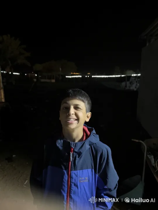 Person Smoking in Night Outdoors with Distant Lights – AI Generated Video | Hailuo AI
