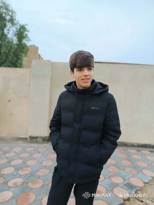 Young Man Smoking by Beige Wall on Cloudy Day – AI Generated Video | Hailuo AI