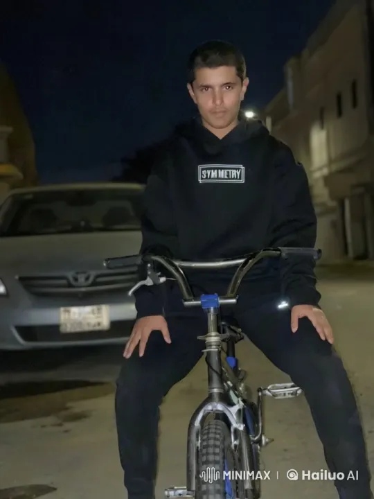 Night Street Reflection: A Young Man on Bicycle Smoking – AI Generated Video | Hailuo AI