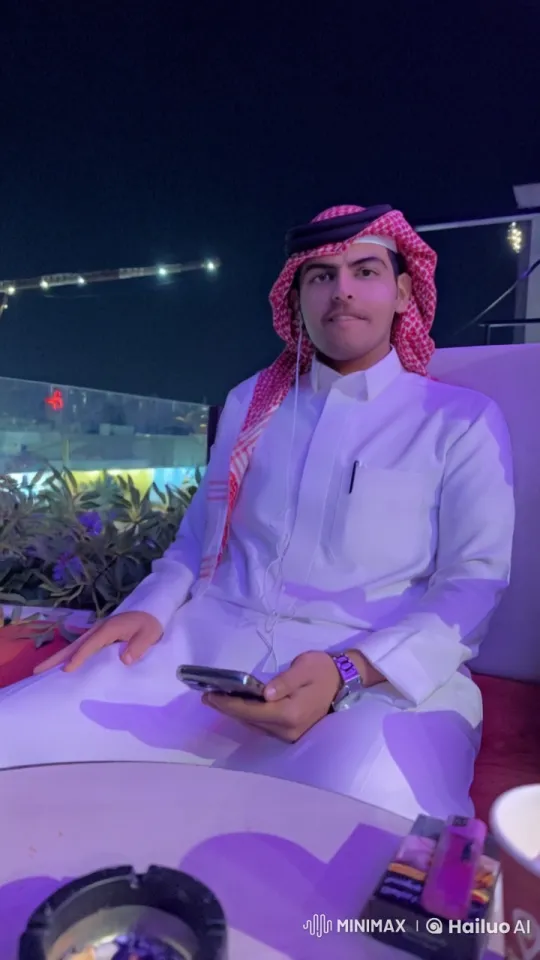 Traditional Attired Person Smokes, Uses Smartphone at Night – AI Generated Video | Hailuo AI