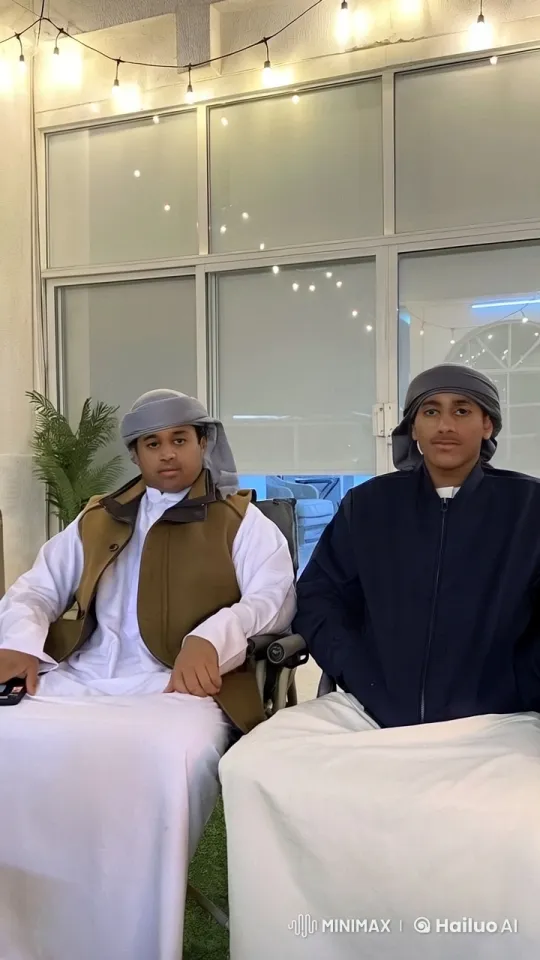 Traditional Attire Men Chat in Cozy, Lit Setting – AI Generated Video | Hailuo AI