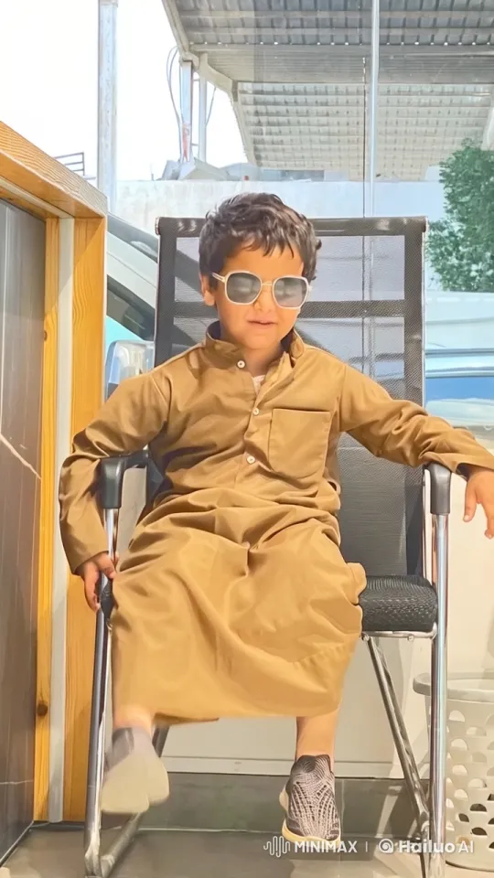 Young Boy Smoking on Patio in Traditional Attire – AI Generated Video | Hailuo AI