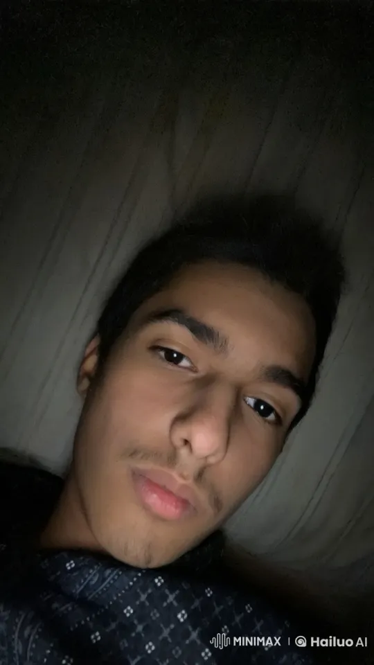 Contemplative Person Smokes in Dimly Lit Bedroom – AI Generated Video | Hailuo AI