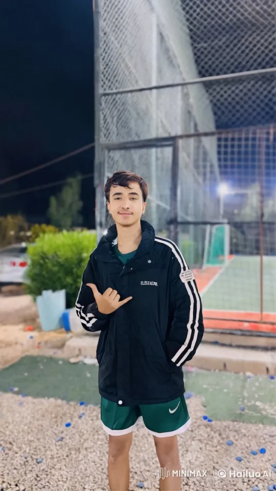 Young Man Smoking by Nighttime Sports Court – AI Generated Video | Hailuo AI
