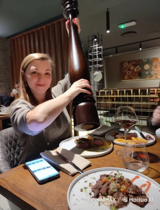 Woman Seasoning Steak with Pepper in Cozy Restaurant – AI Generated Video | Hailuo AI