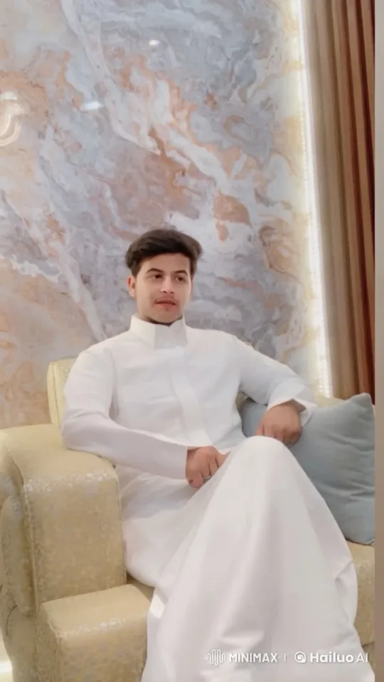 Relaxed Man in Thobe Amidst Elegant Marble Setting – AI Generated Video | Hailuo AI