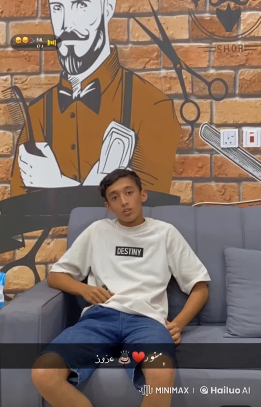 Young Person Mimics Smoking on Gray Couch with Barber Mural – AI Generated Video | Hailuo AI