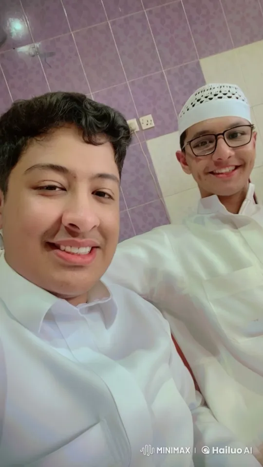 Quiet Moment: Two Men, One Smoking, in a Purple and White Room – AI Generated Video | Hailuo AI