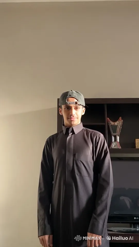 Man in Black Thobe Smokes Leisurely in Dimly Lit Room – AI Generated Video | Hailuo AI