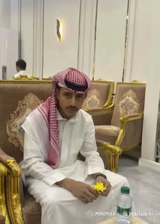 Man in Thobe Smokes, Holds Flower in Luxurious Room – AI Generated Video | Hailuo AI