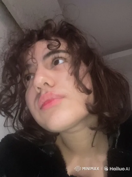 Curly-Haired Person Smoking Indoors with Calm Atmosphere – AI Generated Video | Hailuo AI