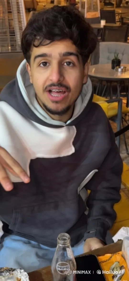 Young Man Relaxing in Cozy Café with Cigarette – AI Generated Video | Hailuo AI