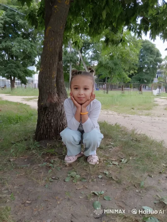 Child Resting Under Tree in Peaceful Park Scene – AI Generated Video | Hailuo AI