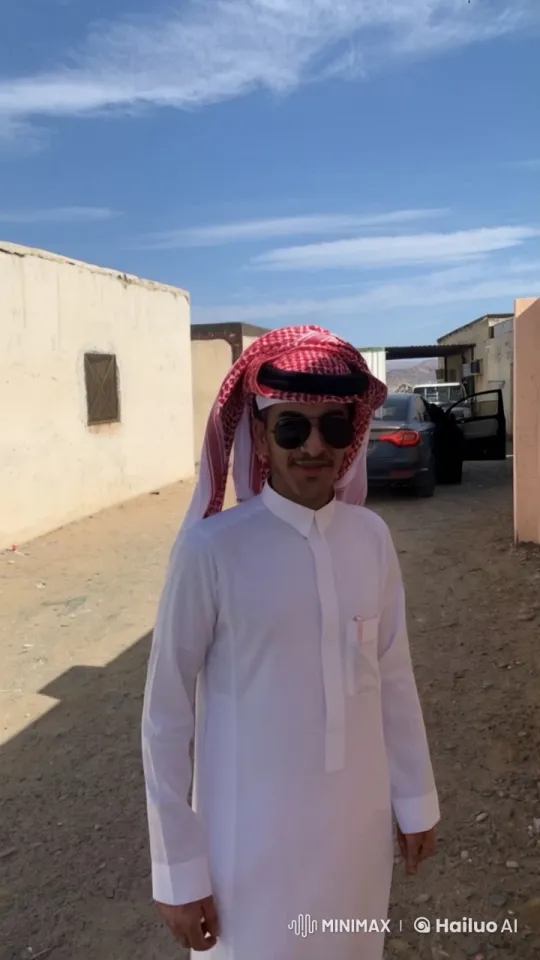 Man Smoking Leisurely in Sandy Area with Buildings – AI Generated Video | Hailuo AI