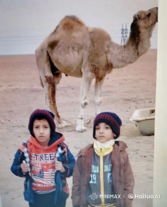 Children Embrace in Desert with Grazing Camel – AI Generated Video | Hailuo AI