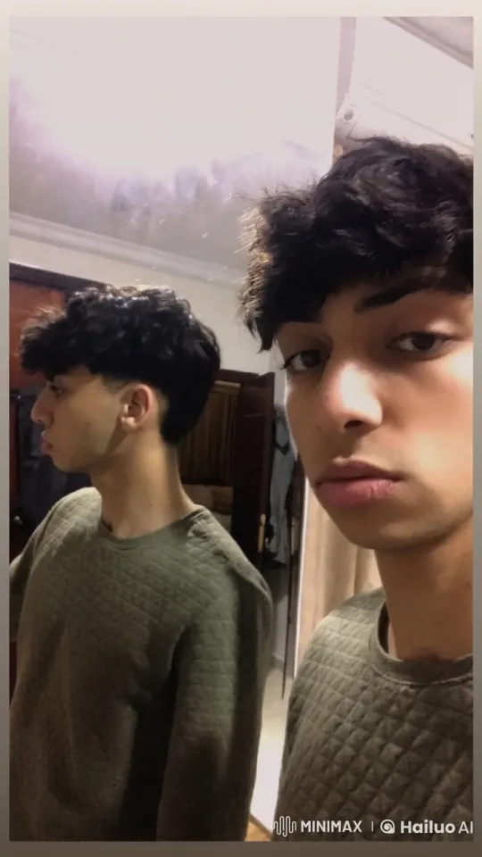 Young Man Reflecting as He Smokes Indoors – AI Generated Video | Hailuo AI